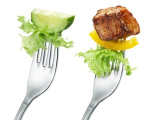 A fork with only vegetables and a fork with vegetables and meat