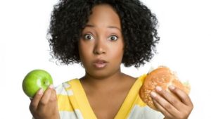 Woman with apple and burger