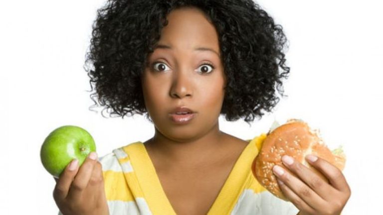 Woman with apple and burger