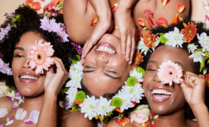 Black women manifest a soft life laughing with flowers