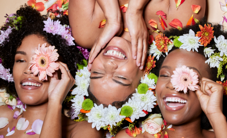 Black women manifest a soft life laughing with flowers