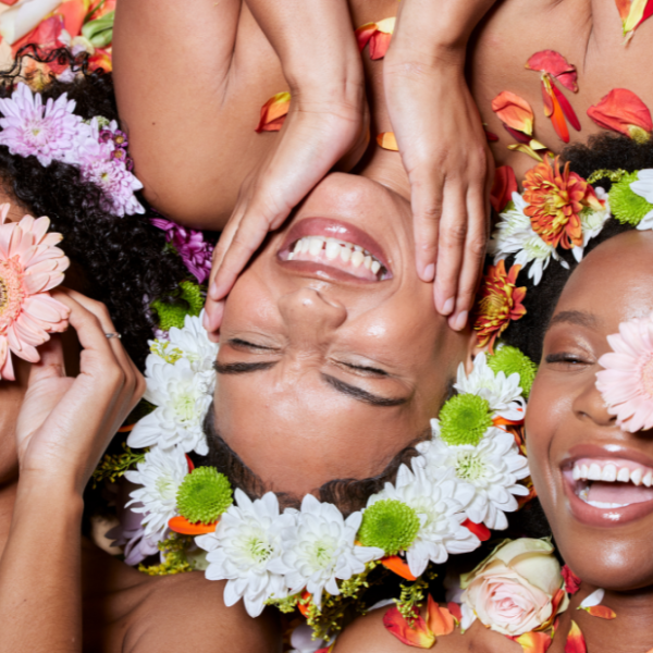 Black women manifest a soft life laughing with flowers