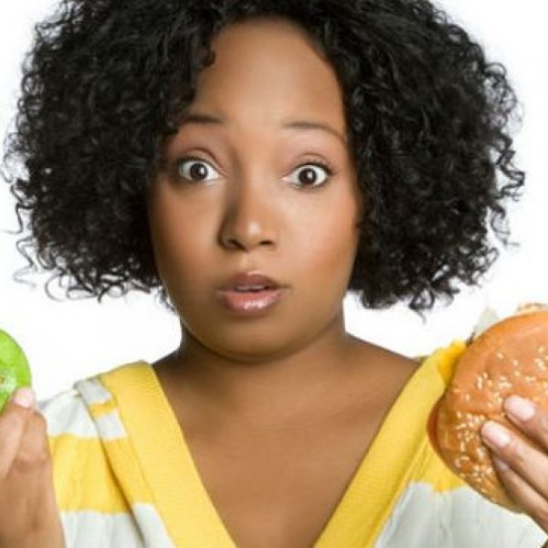 Woman with apple and burger